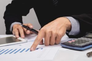 Business people discussing financial charts - closeup shot of ha